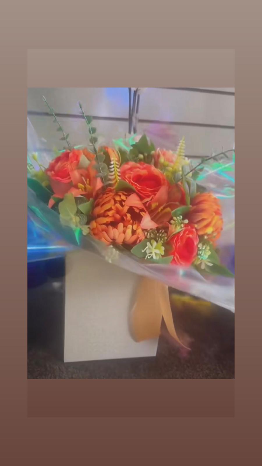 Orange and coral artificial arrangement with roses, chrysanthemums and eucalyptus in a cream box