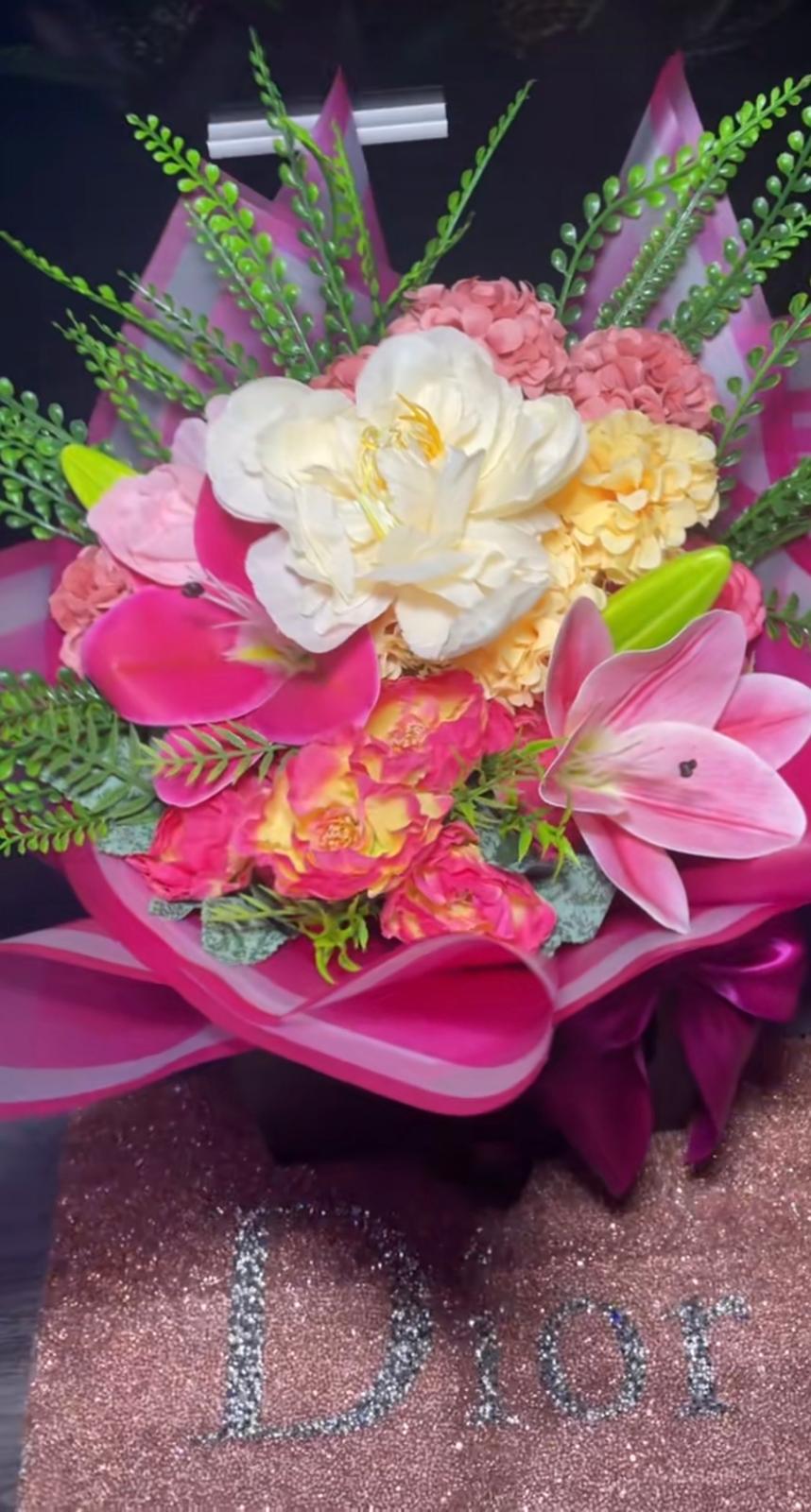Bright pink and cream artificial bouquet with peonies, lilies, hydrangea and trailing greenery