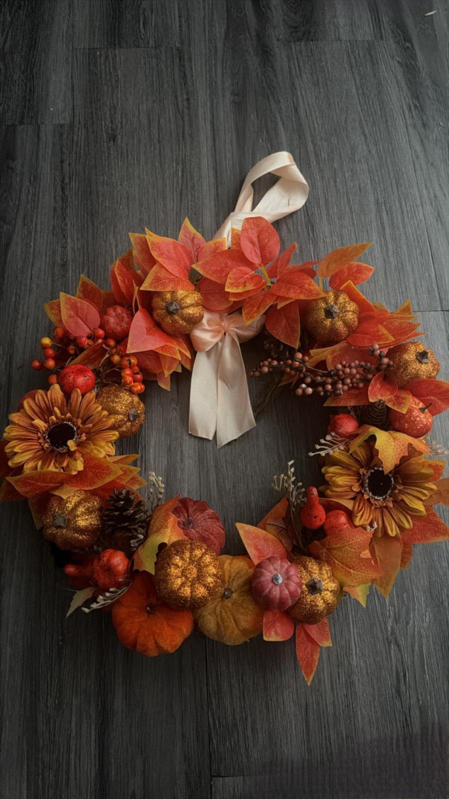 Autumn door wreath with glittered gold pumpkins, sunflowers, berries and orange foliage